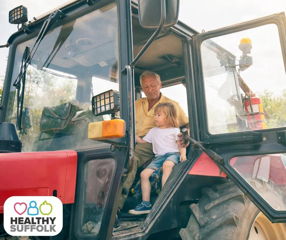Grandfather and child on a tractor