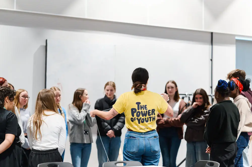 A group of young people in a circle having a discussion about youth social action.