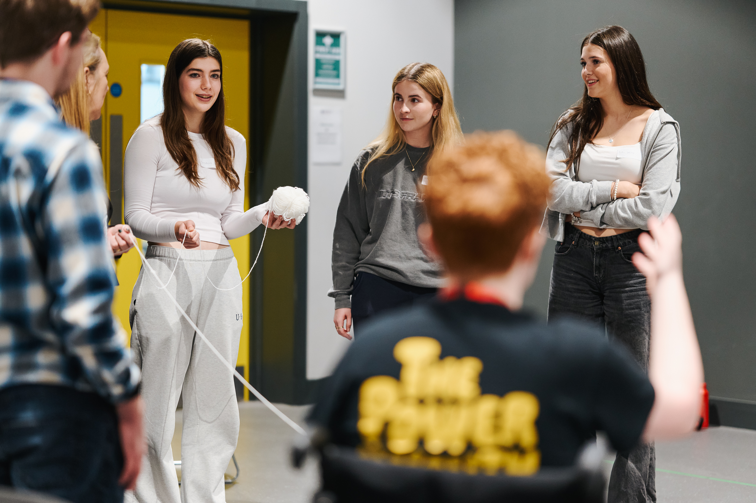 A group of young people discussing something in a group.