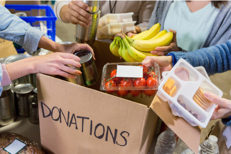 Food being placed in donations box.
