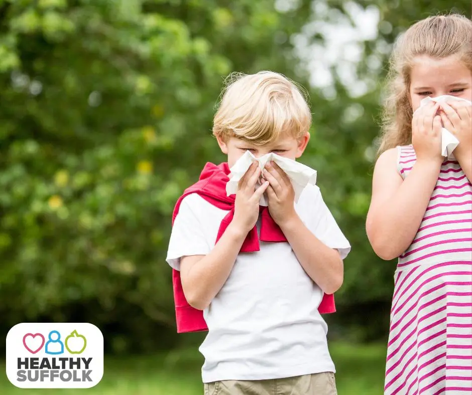 Children sneezing into tissues