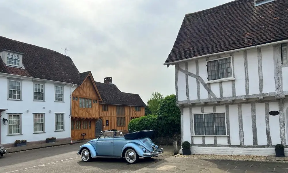 Historic houses with a classic car parked in front