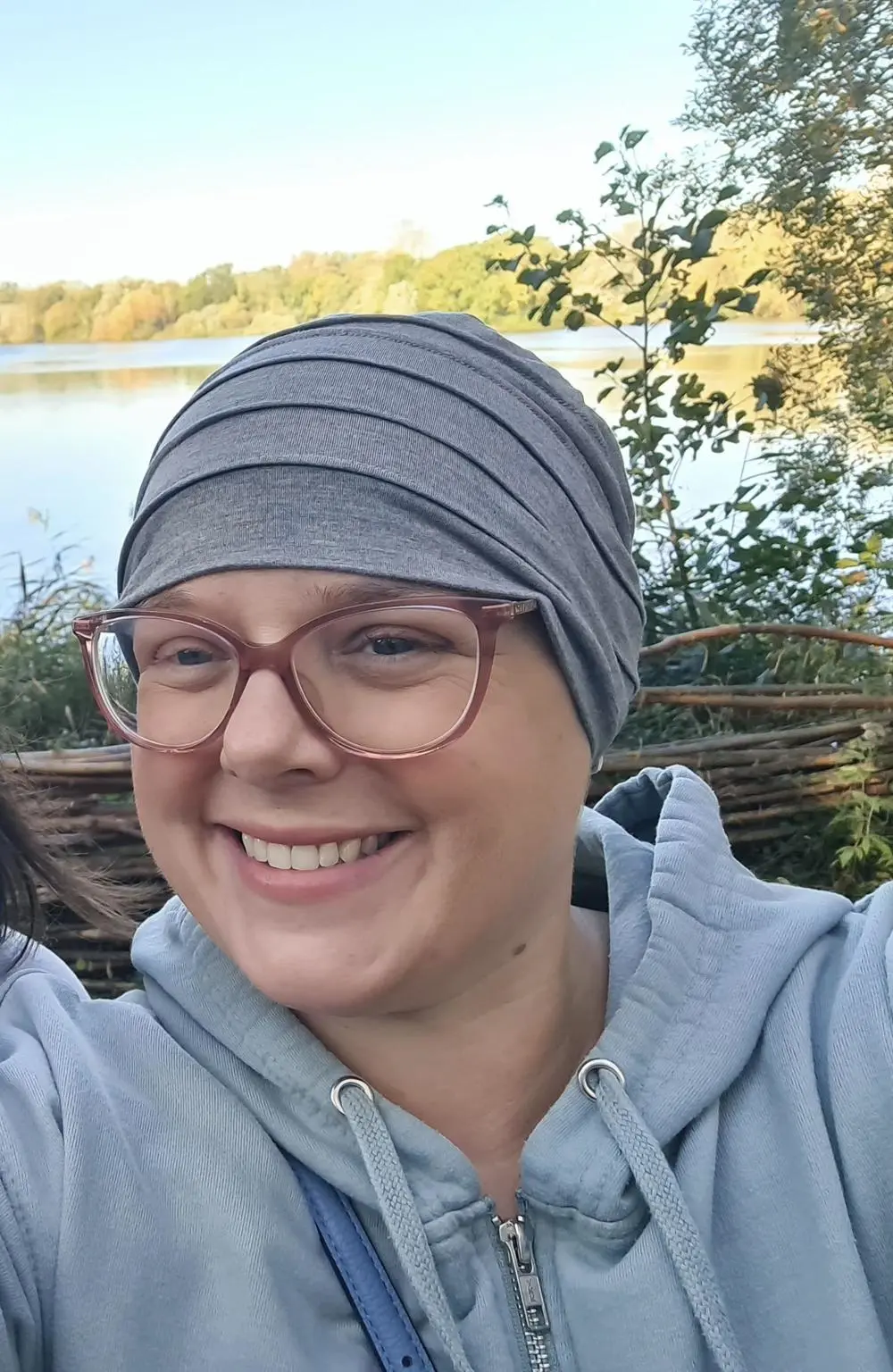 An image of Michelle who is wearing glasses and a head scarf.