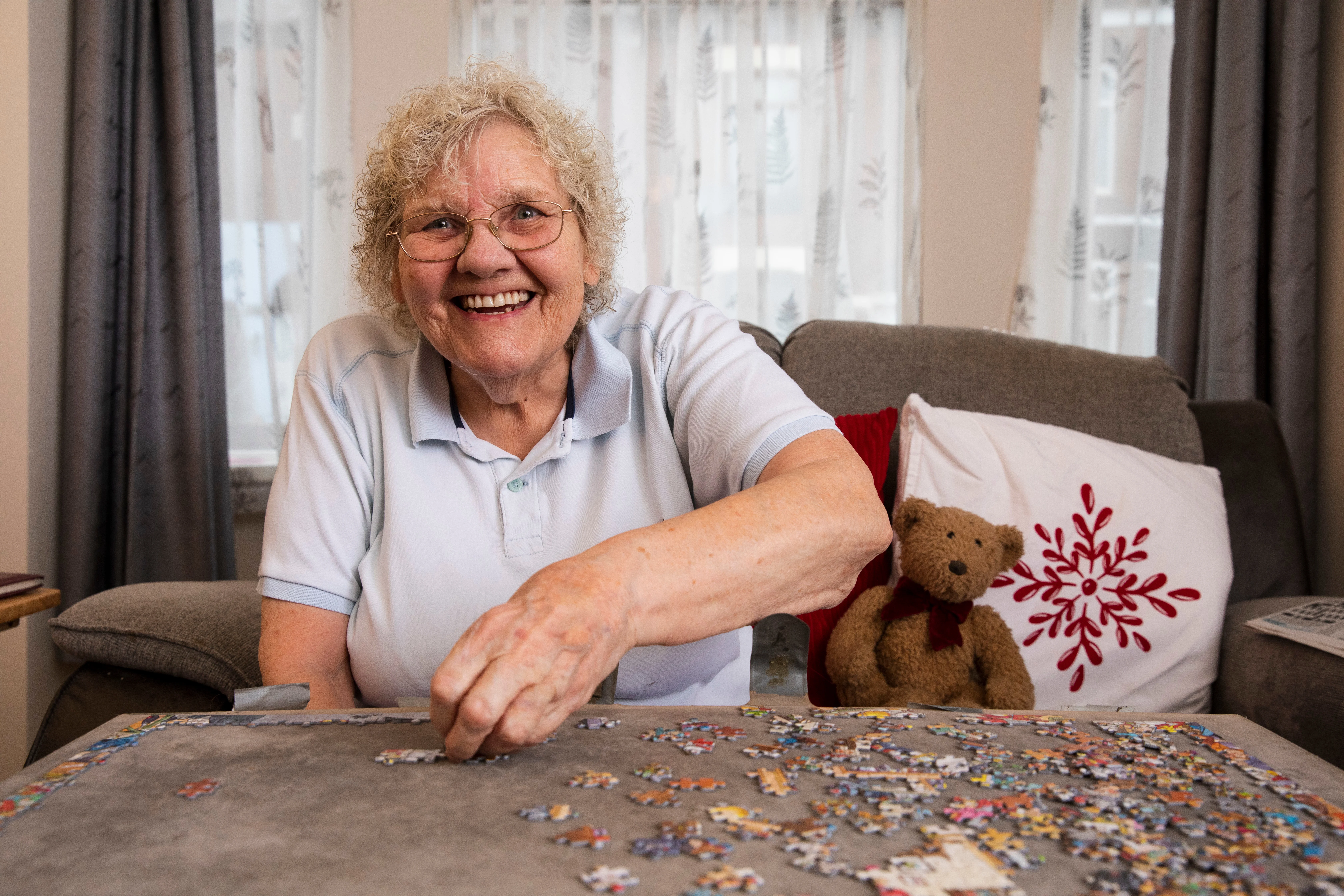 Older women smiling whilst completing a puzzle
