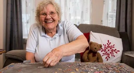 Older women smiling whilst completing a puzzle