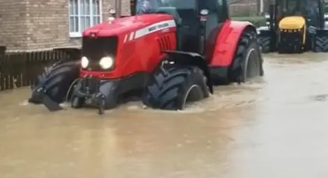 A tractor helping during the emergency response to Storm Babet in Suffolk